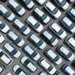 Aerial,View,Of,New,Cars,Stock,At,Factory,Parking,Lot.