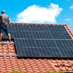 Two,Men,Installing,New,Solar,Panels,On,The,Roof,Of