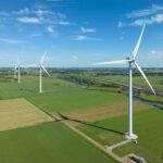 Aerial,Drone,Photo,Of,Four,Wind,Turbines,Near,The,Town
